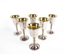 A set of six silver goblets.