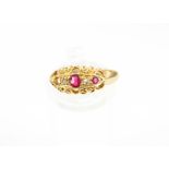 An early 20th century 18ct gold, red-paste and tiny rose diamond ring.