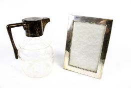 A late Victorian silver mounted clear cut glass claret jug and a photograph frame.