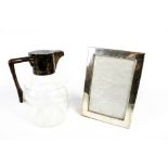 A late Victorian silver mounted clear cut glass claret jug and a photograph frame.