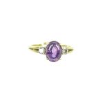 An 18ct gold, amethyst and diamond three stone ring.