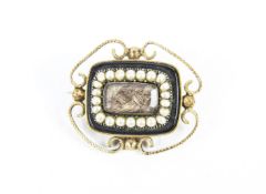 A Victorian gold, half-pearl and black onyx mourning brooch.