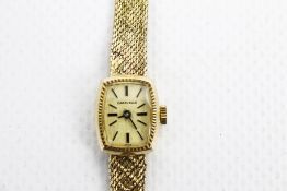 Caravelle, a lady's 9ct gold tonneau shaped bracelet watch.