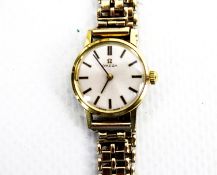Omega, a lady's gold-plated and stainless steel wristwatch.