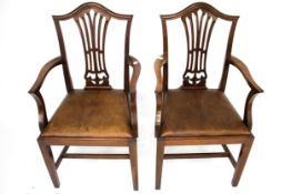 A pair of 19th century mahogany framed open arm carver dining chairs.