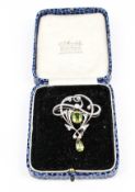 An Art Nouveau peridot and diamond brooch.