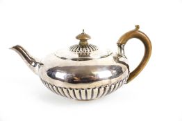 A George IV silver compressed-round and part fluted teapot.