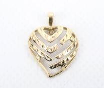 A vintage Continental yellow metal and diamond pendant in the form of an openwork 'witch's heart'.
