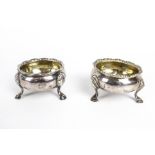 Two similar 18th century silver cauldron-shaped salt cellars.