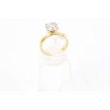 A modern 18ct gold and diamond solitaire ring, The round brillant approx. 2.