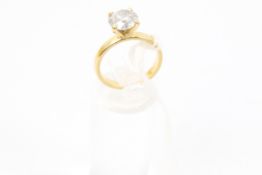 A modern 18ct gold and diamond solitaire ring, The round brillant approx. 2.