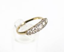 A modern 9ct gold and cubic zirconia five stone cast half-hoop ring.