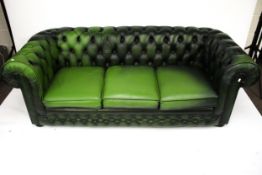 A late 20th century green leather button back Chesterfield settee.