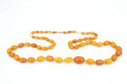 An early 20th century amber oval-bead necklace.