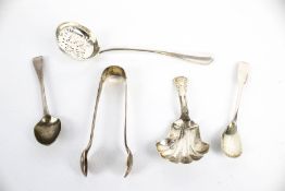 A late Victorian crested silver rat tail sifter spoon, three small spoons and a sugar tong.