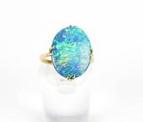 An oval opal-doublet single stone ring. The flat panel measures approx. 17mm x 13mm x 3.