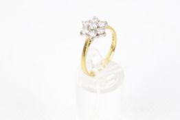 A vintage 18ct gold and diamond seven stone cluster ring. the round brilliants approx. 1.