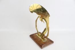 An Art Deco brass parrot and stand rocking figure.