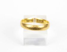 A 22ct gold wedding band.