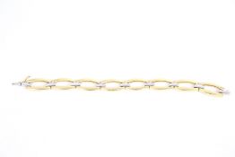 A modern Italian bi-colour gold open ellipse-shaped link bracelet.