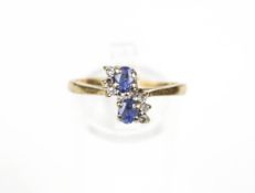 A 9ct gold, sapphire and diamond cross-over ring.