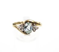 A vintage oval aquamarine(?) and small diamond cross-over ring. Size O+, 3.