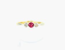 An early 20th century gold, synthetic-ruby and diamond three-stone ring.