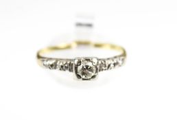 A vintage diamond single stone ring with diamond shoulders. The central round brilliant approx. 0.