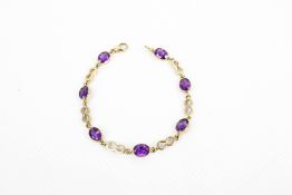 A 9ct gold and amethyst seven-stone bracelet.