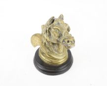 A Victorian inkwell in the form of a heavy horse in harness mounted on a circular slate socle.