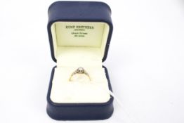 A vintage gold and small diamond solitaire ring. The round brilliant approx. 0.