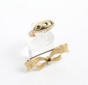 A vintage 9ct gold bow-shaped fob brooch and a ring.