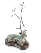 A Scandinavian(?) 'Sterling Silver' and turquoise ring tree in the form of a recumbent deer.