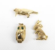 Three 9ct gold bird or animal pendants or charms including an owl.