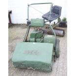 An Atco rotary ride on petrol lawn mower with grass collector.