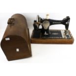A vintage Singer sewing machine. Model Y877351, hand crank, with some accessories, cased.