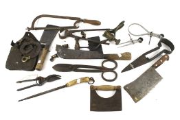 A collection of vintage hand tools. Including butchers cleavers, shears, snips, and saws, etc.