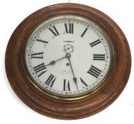 A vintage oak cased circular wall clock. Kemp Bros. Bristol.