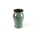 A contemporary Blagdon Lustre vase. Glazed in green and blue, with a flared rim, H27.