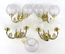 A set of four contemporary brass wall lights. Comes with nine assorted glass shades. H16.