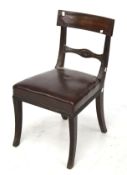 A mahogany framed chair. With leather seat and saber supports.