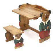 A child's nursery carved wooden desk and stool. With carved teddy bear supports.