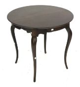 A circular mahogany 'rent' table. On cabriole supports and four small drawers.