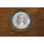 An Edwardian tondo miniature portrait painting. A watercolour on ivory portrait of a young girl.