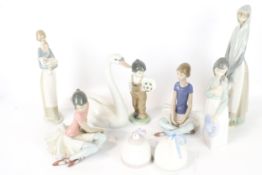A collection of Lladro and Nao figures.