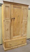 A vintage 2 piece pine wardrobe. With single panelled door above a single drawer.