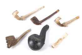 A collection of clay pipes and a Mersham pipe.