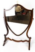 A early 20th century mahogany veneered swing mirror.