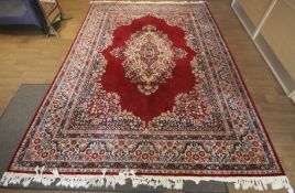 A Royal Emir Persian style wool rug. Red,cream and blue.