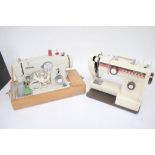 Two vintage electric sewing machines.